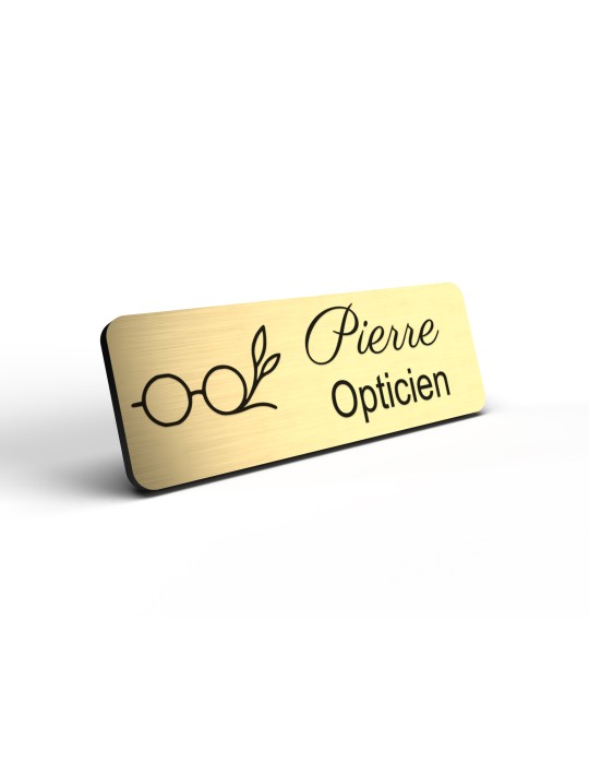 Badge personnalisé opticien, motif optique et lunetterie, détail de la finition or brossé