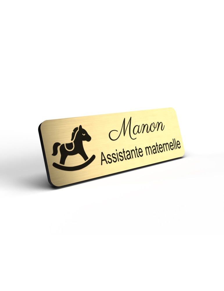 Badge personnalisé assistante maternelle, motif accueil familial et petite enfance, détail de la finition or brossé